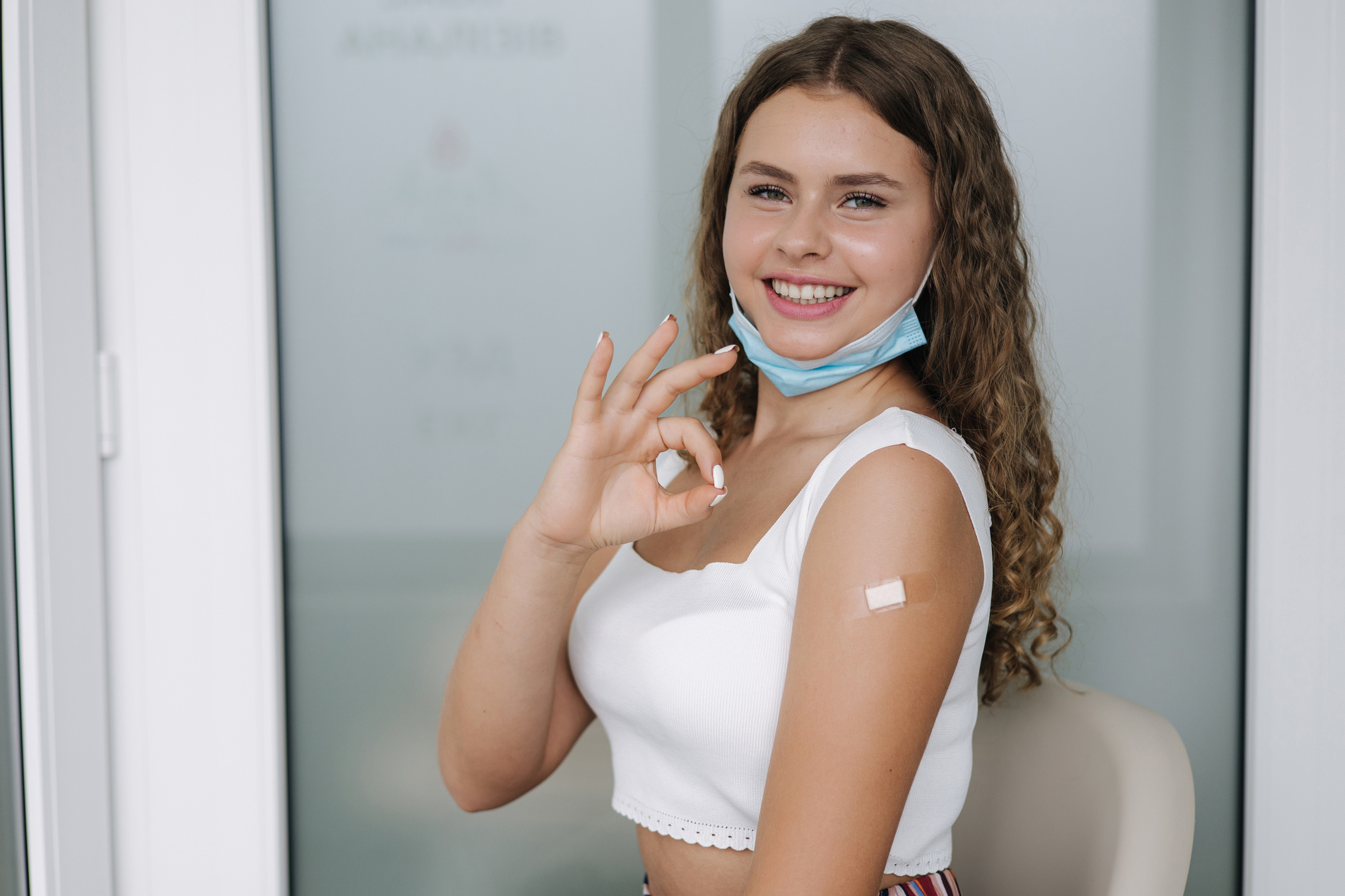 Woman Showing an OK Sign After Receiving Vaccine Shot